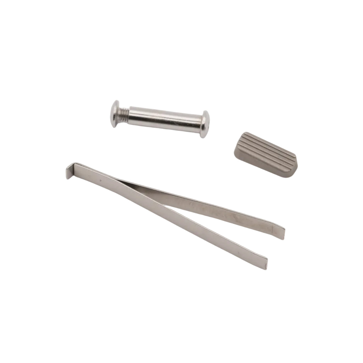 A small set of metallic hardware pieces, including a silver cylindrical pin, a flat metal clip, and a textured gray rectangular piece, arranged on a plain white background.